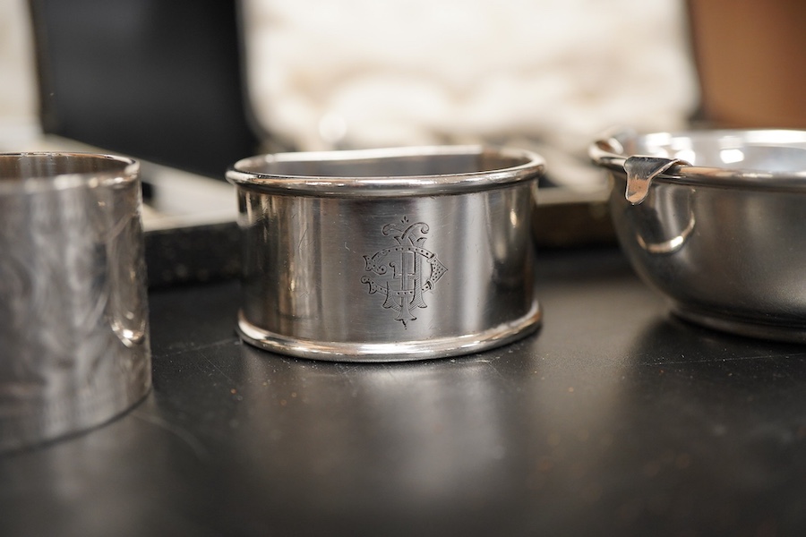 Two cased sets of six mid 20th century silver coffee spoons including Barker Brothers Silver Ltd, Birmingham, 1940, together with a silver and sterling napkin rings and a silver tea strainer on stand.
